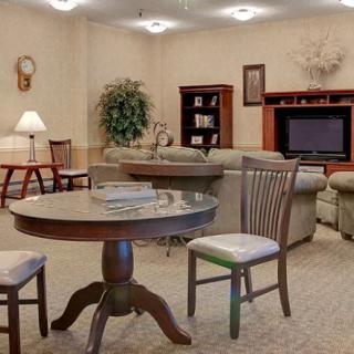 A cozy living room with comfortable seating and a TV entertainment center.