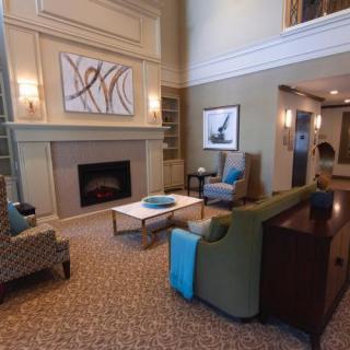 A cozy and modern living room featuring a fireplace, comfortable seating, and elegant decor.
