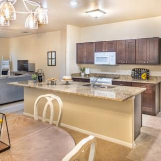 A modern kitchen with an open-plan design featuring an island counter and dining area.