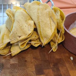 Folded tortillas held together with toothpicks, prepared for cooking.