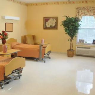 An empty hospital room with neatly arranged furniture and a comforting atmosphere.