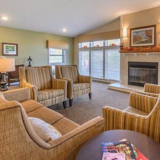 A cozy living room with comfortable seating and a fireplace.