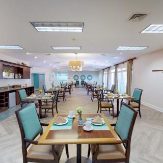 A modern dining room with neatly arranged tables and chairs, ready for guests.