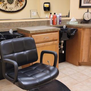 A salon interior with a barber chair and sink.