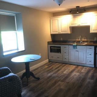 A cozy kitchen space featuring a small dining table and modern cabinetry.