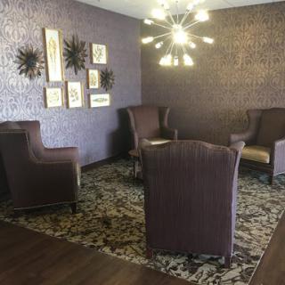 A stylish living room setup featuring cozy seating, modern decor, and ambient lighting.