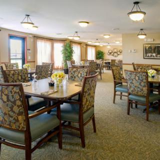 A cozy dining area featuring elegant furniture and soft lighting, perfect for communal meals.