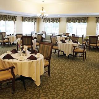 A well-decorated dining room with neatly arranged tables and chairs.