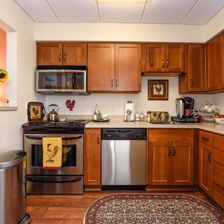 A cozy kitchen with wooden cabinets and stainless steel appliances.