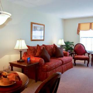 A cozy living room with a red sofa and elegant decor.