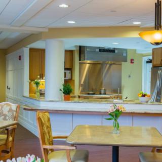 A modern kitchen and dining area with cozy decor and warm lighting.