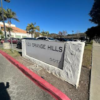 Entrance sign for Orange Hills community on a bright, sunny day.