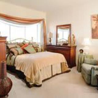 A cozy bedroom with elegant furnishings and warm decor.