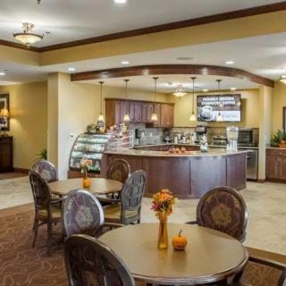 A cozy cafe interior with a seating area and a display counter.