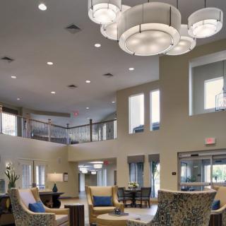 A modern and spacious lobby with elegant chandeliers and comfortable seating areas.