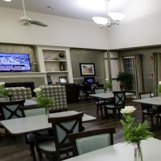 A cozy dining area with modern decor and a television on the wall.