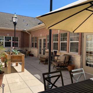 A sunny patio with outdoor furniture and plants.