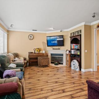 A cozy living room with a fireplace, television, and comfortable seating.