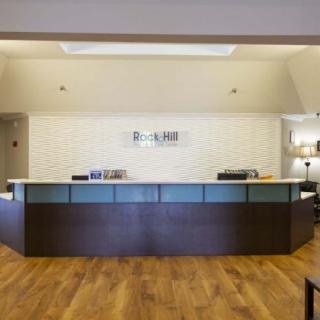 A modern hotel reception desk in a lobby.