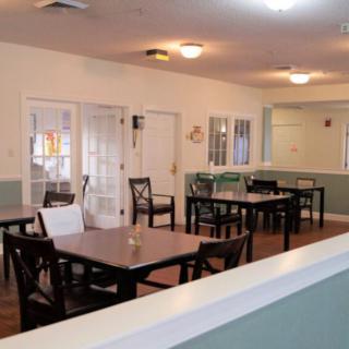 An empty dining area with neatly arranged tables and chairs.