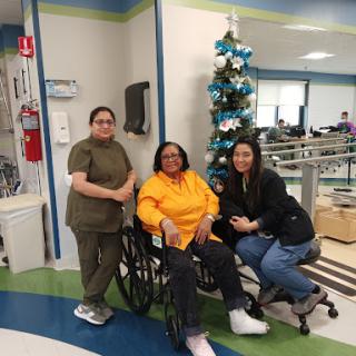 A moment of support and togetherness in a healthcare setting, featuring holiday decorations.