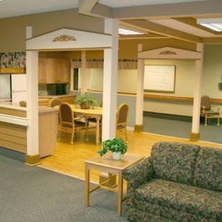 A spacious waiting area with comfortable seating and decorative plants.