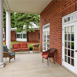 A cozy outdoor porch area featuring comfortable seating and a welcoming atmosphere.