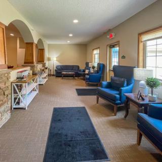A cozy living room with comfortable seating and warm lighting.