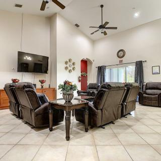 Spacious living room with leather recliners and modern decor.