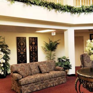 Elegant lobby area with decorative plants and artwork.