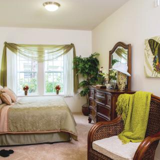 Cozy bedroom with elegant decor and natural light.