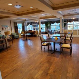 A cozy lounge area with comfortable seating and ample natural light, perfect for relaxation or socializing.