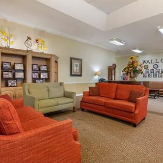 A cozy living room with colorful sofas arranged for comfortable seating.