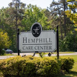 Entrance to Hemphill Care Center surrounded by greenery.