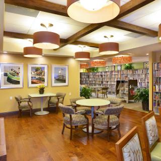 A cozy and modern library space featuring comfortable seating and vibrant artwork.