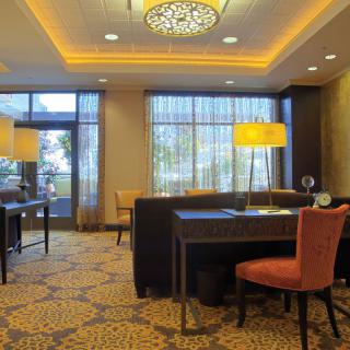 A cozy hotel lobby with elegant lighting and comfortable seating arrangements.