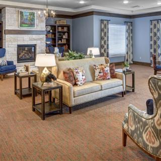 A cozy living room with comfortable furniture and a warm fireplace.