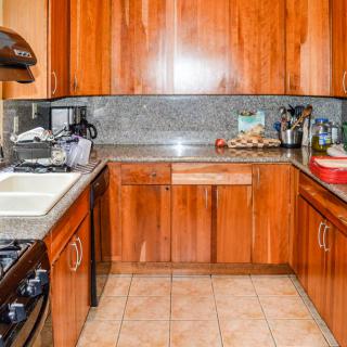 A modern kitchen with wooden cabinets and various appliances.
