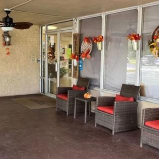 A cozy outdoor seating area with autumn-themed decorations.