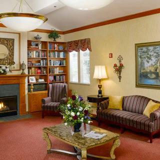 A cozy living room with elegant furniture, a fireplace, and decorative elements.