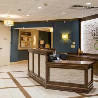 A modern hotel lobby featuring a stylish reception desk and comfortable seating.