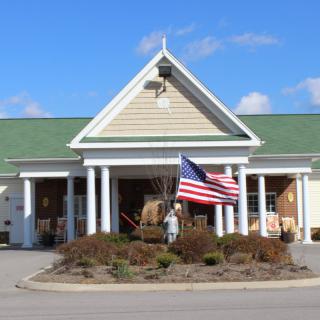 A building with an American flag at the entrance on a clear day.