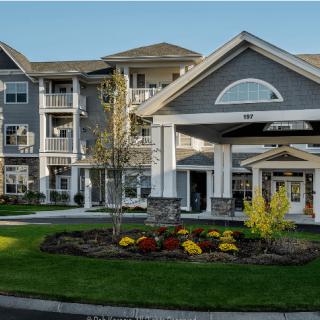 A modern residential building with a landscaped entrance.