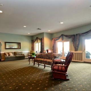 A spacious living room with elegant furniture and large windows.