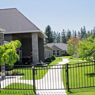 A peaceful residential area with well-maintained yards and a gated walkway.