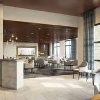 A modern lounge area with comfortable seating and large windows.