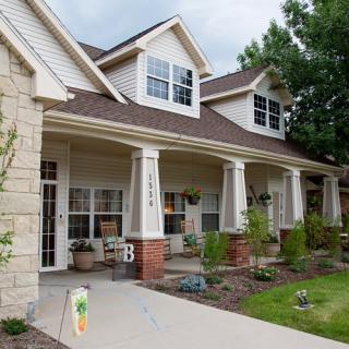 A suburban house with a well-maintained lawn and inviting front porch.