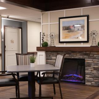 A modern interior with a stone fireplace and elegant decor.