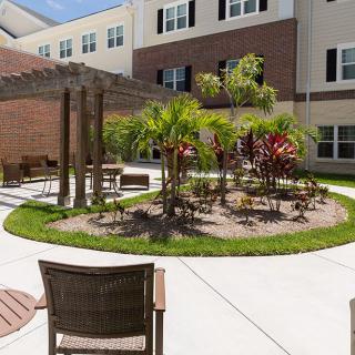 A tranquil courtyard with outdoor seating and a landscaped garden.