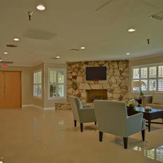 A modern and inviting lobby area featuring comfortable seating and a cozy fireplace.